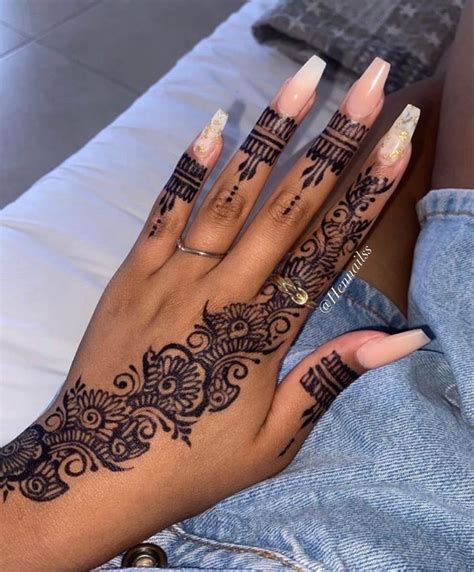 A Woman S Hand With Henna Tattoos On It