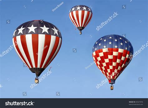 Stars And Stripes Hot Air Balloons Against A Bright Blue Sky Stock