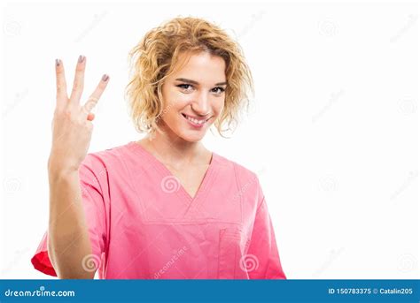 Portrait Of Nurse Wearing Pink Scrub Showing Number Three Stock Image