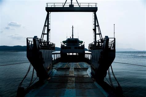 Premium Photo Ship Moored At Shore Against Sky