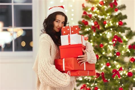 Premium Photo | Funny christmas santa woman with gifts at home