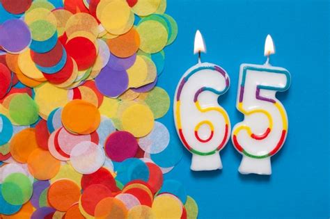 Premium Photo Number 65 Celebration Candle With Party Confetti