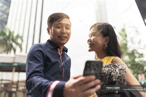 Happy Young Asian Couple Taking Selfie Together — Black Hair Building