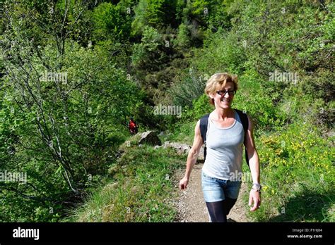 Mature Female Hiker Hiking Up Hillside Path Stock Photo Alamy