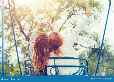 Two Girls Taking Selfie While Having Fun In Amusement Park Stock Image