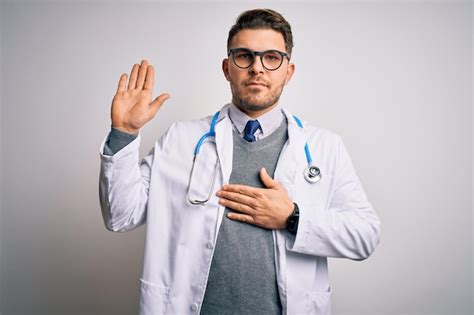 Premium Photo Young Doctor Man With Blue Eyes Wearing Medical Coat