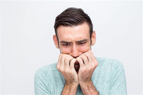 Free Photo | Closeup of Nervous Young Man Biting Nails