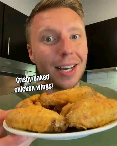 A Man Holding A Plate With Fried Chicken Wings On It And The Caption Reads Crispy Baked Chicken