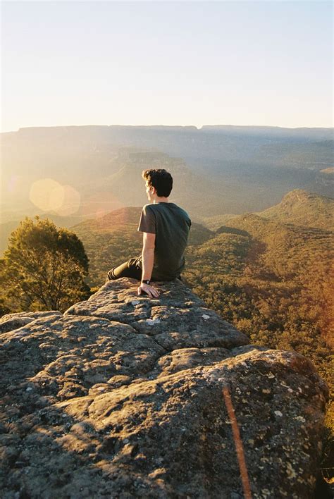 HD Wallpaper Man Sitting On Rocks Looking Backwards Man On Cliff