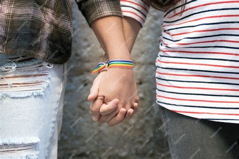 Premium Photo Close Up Of Happy Lesbian Couple Holding Hands Wearing