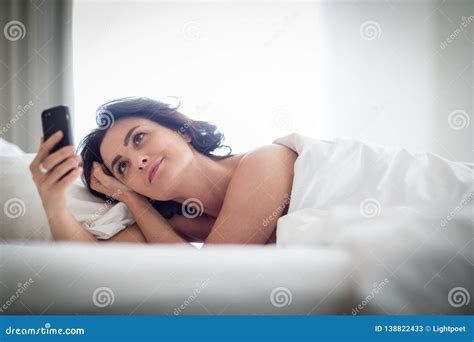 Beautiful Young Woman Using Her Cell Phone In Bed Stock Image Image