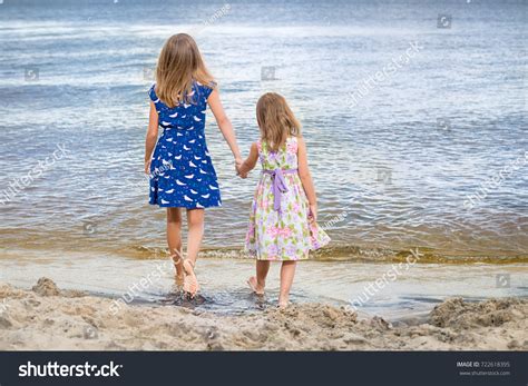 Two Sisters Holding Hands