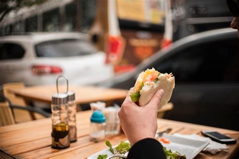 Free Photo | Close-up person eating a burger