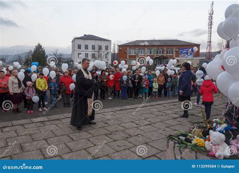 Orthodox Priest And People With White Balloons On The Day Of Mourning