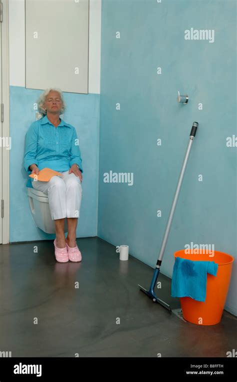 Exhausted Senior Woman Sitting On Toilet Bowl Stock Photo Alamy