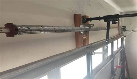 how to put the garage door back on track