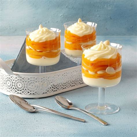 Three Desserts In Small Glasses On A Tray With Silverware And Utensils