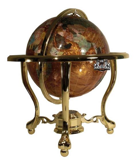 An Antique Globe On A Stand With Gold Accents