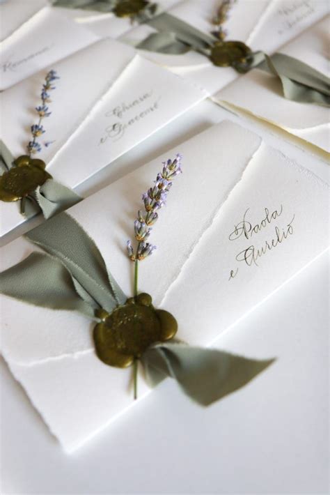 The Wedding Stationery Is Laid Out On Top Of Each Other With Ribbons