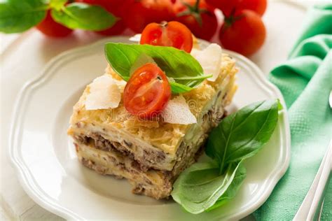 Homemade Lasagna With Bechamel Sauce Decorated Basil Leaves And Cherry