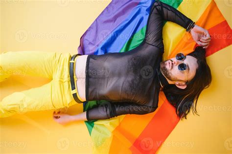 Handsome Young Man With Pride Movement Lgbt Rainbow Flag On Shoulder Against White Background