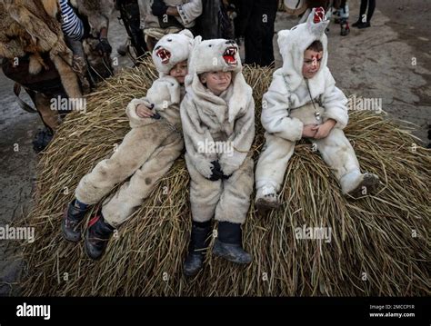 Children dressed in bear costumes, pose for a photo while celebrating ...