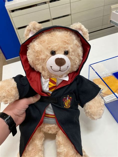 A Teddy Bear Dressed In A Harry Potter Outfit Is Being Held By Someone