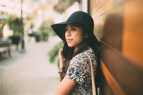 «attractive Young Woman In Sun Hat Leaning Against Wall Del