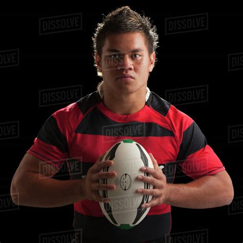 Studio Portrait Of Male Rugby Player Holding Ball Stock Photo Dissolve