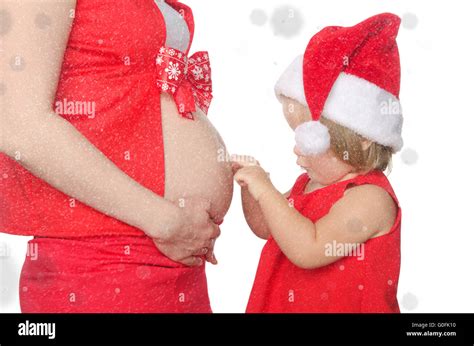 Child And Pregnant Woman Belly At Christmas Snowflakes Stock Photo Alamy