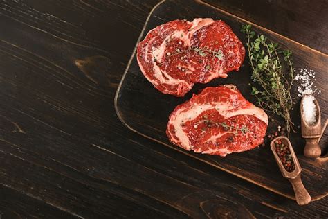 Two Raw Marbled Beef Steaks In Olive Oil And Spices Ready For Frying