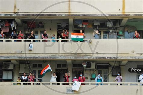 Image Of People Clap And Bang Utensils From Their Balconies To Cheer