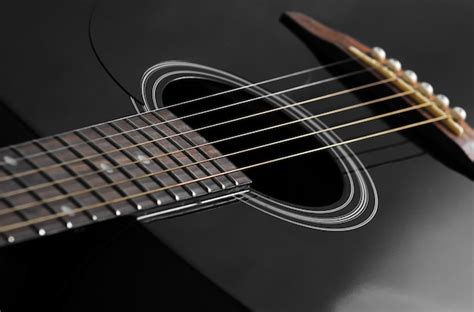 Premium Photo Strings From A Black Acoustic Guitar