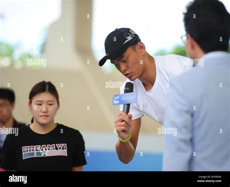 Chinese swimming star Sun Yang attends an open class in a swimming pool in Sanya city, south ...