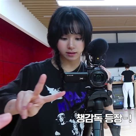 A Person Holding A Camera And Pointing At It With Two Hands In Front Of Them