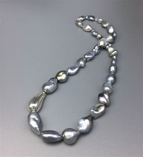 A Beautiful Tahiti Keshi Pearl Necklace Embellished With A Hand Made