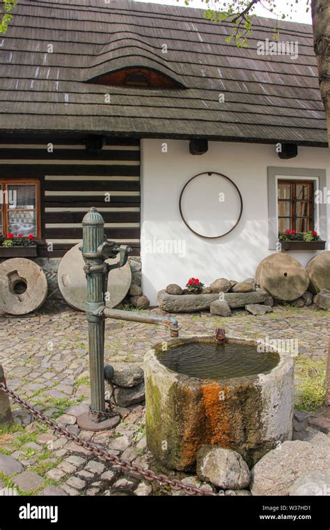 Water Column Well In Cozy Old Courtyard Through Rhombus Window With