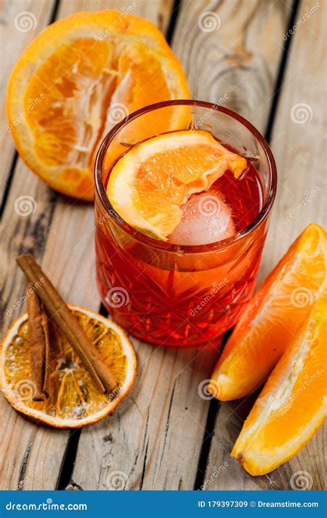 Classic Negroni Cocktail With Orange Slice In A Glass On A Wooden Background With Lines