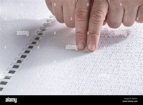 Hand Of A Blind Person Reading Some Braille Text Touching The Relief