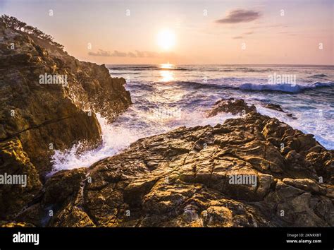 Enchanting Beach Landscape Of Coastal Rocks And Dynamic Ocean Spray