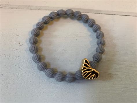 Lupe Wing Charm Hairband Bracelet Grey Gold Lizzielane