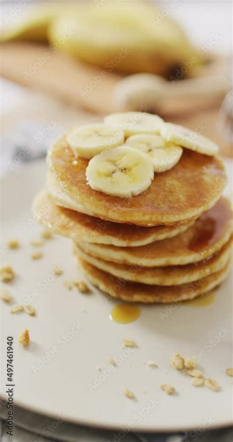 Vertical video of stack of american style pancakes topped with banana ...