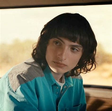 a young man sitting in the back seat of a car