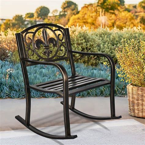 A Black Rocking Chair Sitting On Top Of A Patio Next To A Planter