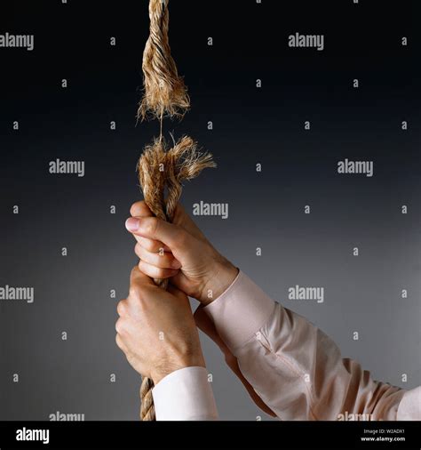 Man Holding Onto The Bottom Of A Rope That Only A String Of Rope Is