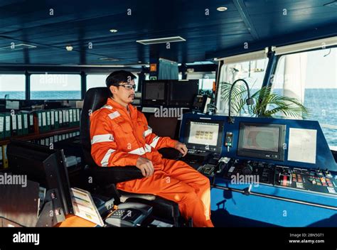 Filipino Deck Officer On Bridge Of Vessel Or Ship He Is Looking