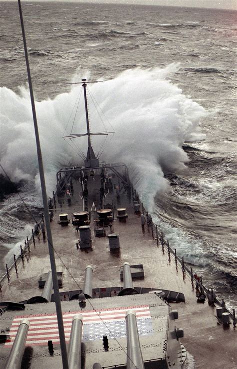 The battleship USS IOWA (BB-61) takes water over the bow while underway ...