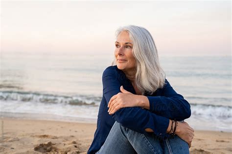 Mature Woman Sitting By Sea By Stocksy Contributor Alba Vitta Studio Stocksy