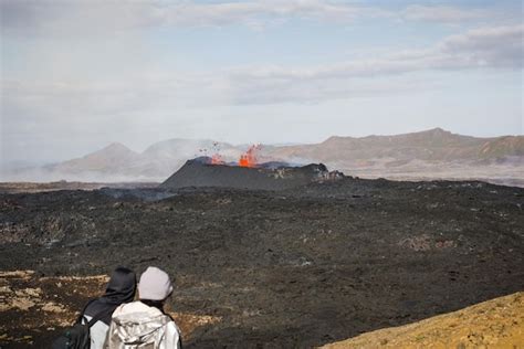 Premium Photo Woman Tourist Looking At Dramatic View Of Dark Volcanic