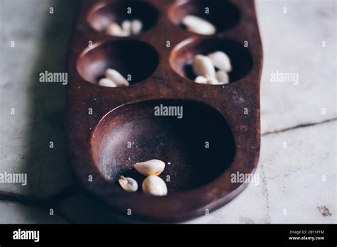 Closeup Of Head Part Of Sungka Philippine Mancala Game On Off White